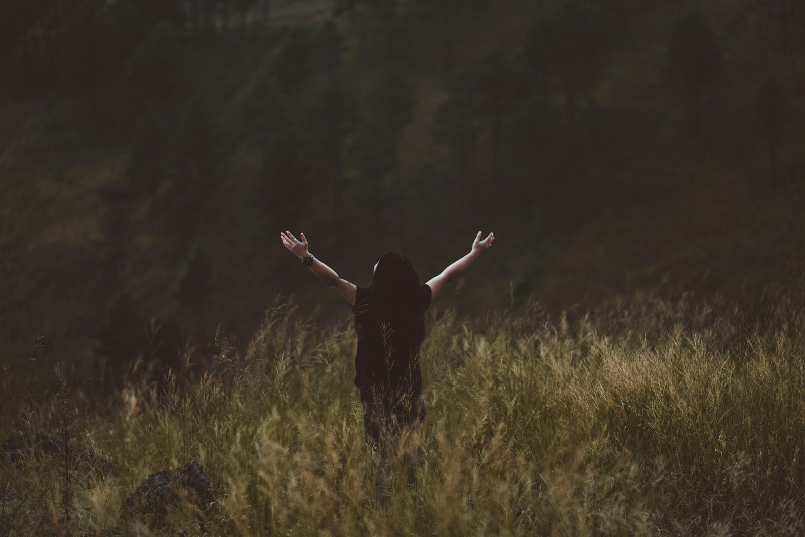 A person with their arms up expressing happiness and freedom